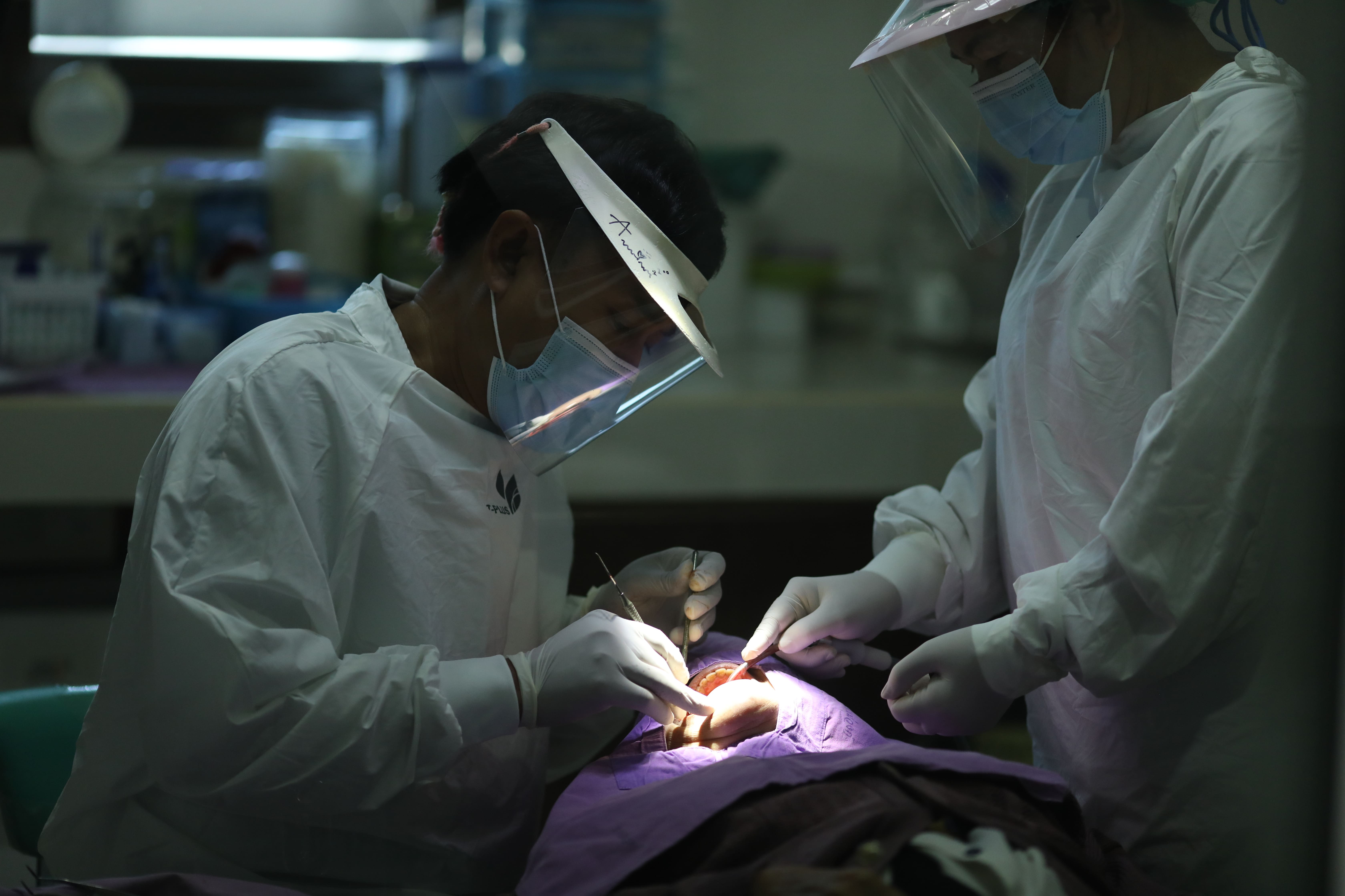 Senior citizens express their gratitude for a health program providing them with dental implants 